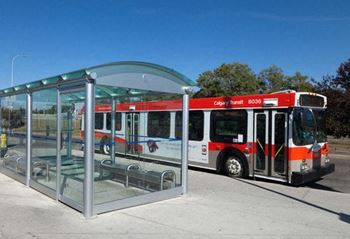 a red and white bus parked at a bus stop